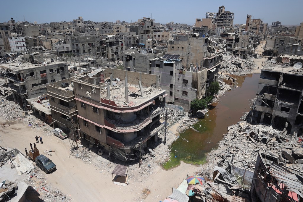 A view of central Khan Younis in Gaza, showing the aftermath of airstrikes in a residential neighborhood. A stream of sewage cuts through the area, the result of destroyed infrastructure, raising fears of disease outbreaks.
